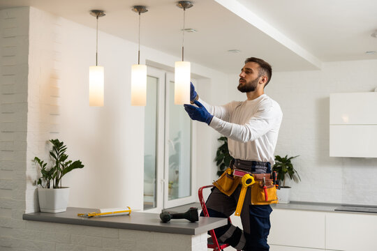 Electrician installing kitchen lighting