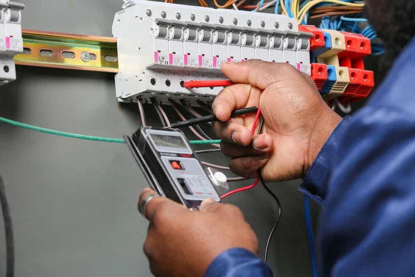 Electrician reading electrical meter